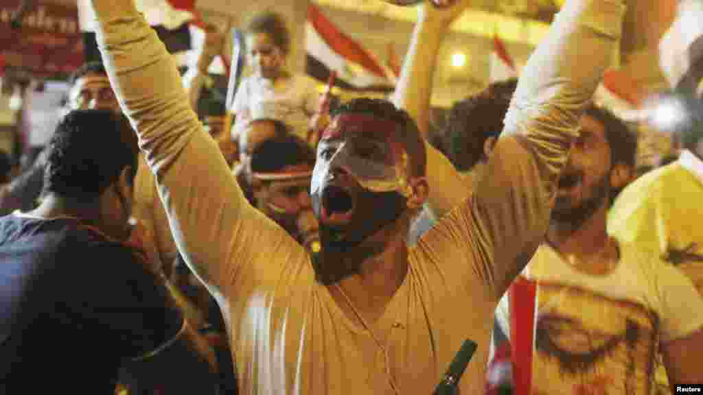 Anti-Morsi protesters chant as they celebrate into the night after the announcement of his removal from office, Tahrir Square in Cairo, July 3, 2013.