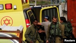 Israeli soldiers stand guard at the scene of an attempted stabbing attack by a Palestinian in Hebron, in the occupied West Bank, March 12, 2019.