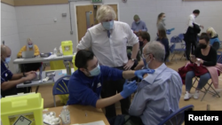 BRITISH PRIME MINISTER BORIS JOHNSON VISITING A VACCINATION CENTRE IN CENTRAL LONDON