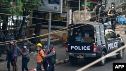 FILE - Police arrest people as part of a crackdown on demonstrations against the military coup, in Yangon, Myanmar, Feb. 27, 2021. Journalists are now being increasingly targeted for detentions. 