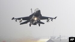FILE - A Taiwan air force F-16 fighter jet scrambles from one section of a highway during a drill in Madou, Tainan city, south of Taiwan, April 12, 2011.