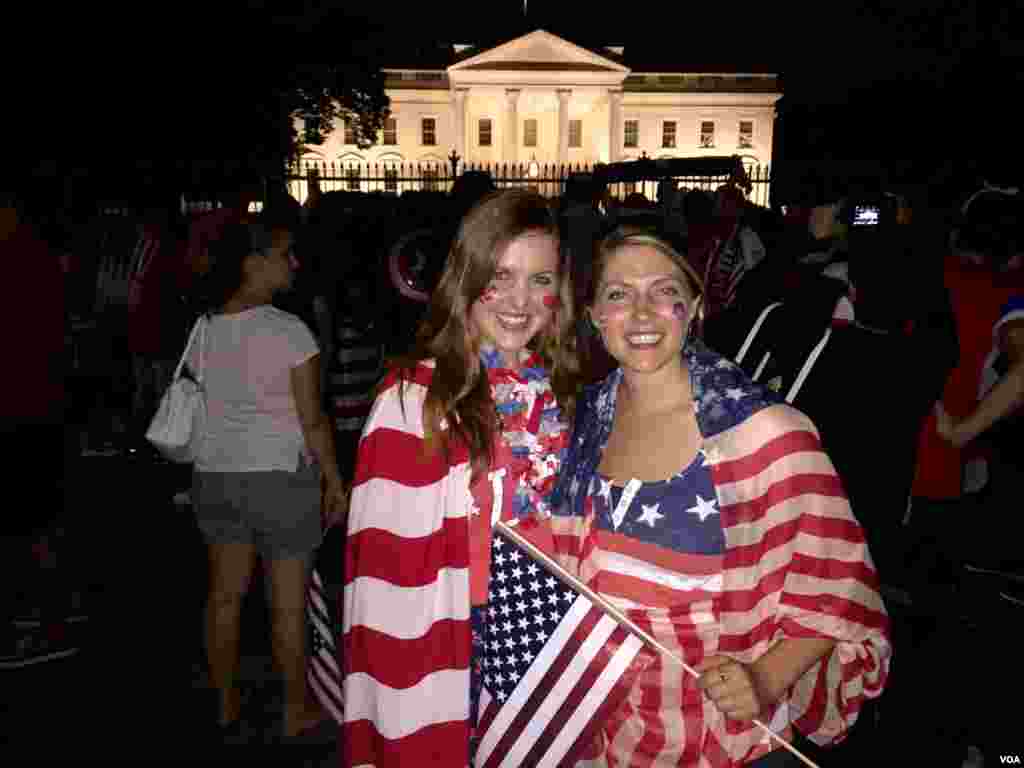 American soccer fans Laura Neff of California (left) and Kayli Westling of Wyoming (right) celebrate the U.S. women’s national team World Cup final victory with the American Outlaws outside the White House, July 5.