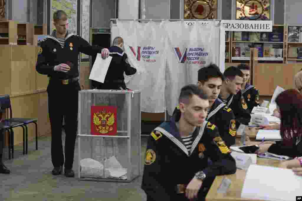 Студенти Морського державного університету імені адмірала Геннадія Невельського беруть участь у голосуванні на виборчій дільниці під час президентських виборів у тихоокеанському портовому місті Владивосток, 6418 км на схід від Москви, Росія, п’ятниця, 15 березня 2024 р. Як кажуть оглядачі, голосування майже напевно продовжить правління президента Володимира Путіна після того, як він придушив опозицію. (Фото: AP Photo)