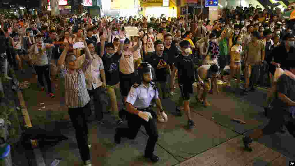 Student protesters mixed with expatriates cause police to retreat in an entertainment area in Hong Kong, late Sept. 28, 2014.