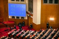 A video screen shows the results of the vote on a piece of national security legislation concerning Hong Kong during the closing session of China's National People's Congress (NPC) in Beijing, China, May 28, 2020.