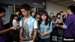Students leave after a Scholastic Assessment Tests (SAT) exam at AsiaWorld-Expo in Hong Kong.