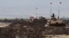 Turkish and Iraqi soldiers sit on Turkish tanks during the exercises in Silopi, near the Habur border gate with Iraq, southeastern Turkey, Sept. 26, 2017.