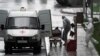 FILE - Medical personnel wearing protective gear move what appears to be a bag containing a human body, outside a hospital for coronavirus patients, on the outskirts of Moscow, Russia, May 12, 2020.