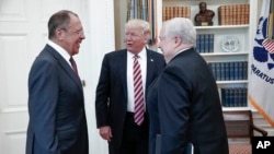 U.S. President Donald Trump meets with Russian Foreign Minister Sergey Lavrov, left, next to Russian Ambassador to the U.S. Sergei Kislyak at the White House in Washington, Wednesday, May 10, 2017. Trump on Wednesday welcomed Vladimir Putin's top diplomat to the White House for Trump's highest level face-to-face contact with a Russian government official since he took office in January. It came the day after Trump fired FBI Director James Comey, who was leading an investigation into Russian interference with the U.S. presidential election. (Russian Foreign Ministry Photo via AP)