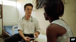 FILE - A physician talks to a patient who is HIV positive at a social and medical assistance clinic in Abidjan, Ivory Coast, Monday March 19, 2001. 