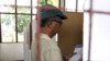 An East Timorese voter checks his ballot at a polling station during the presidential election in Dili, March 17, 2012. 