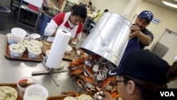 FILE - Mexican workers, on the U.S. H-2B visa program for seasonal guest workers, process crabs in Fishing Creek, Maryland, Aug. 26, 2015. 