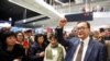 Cambodia's self-exiled opposition party founder Sam Rainsy, who has vowed to return to his home country, gestures to supporters after being prevented from checking-in for a flight from Paris to Bangkok at Roissy Airport in Paris, France Nov. 7, 2019.