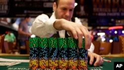 FILE - A dealer adjusts a stack of chips before the first day of the World Series of Poker main event in Las Vegas, Nov. 10, 2014.