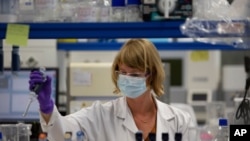 A lab technician works during research on coronavirus, COVID-19, at Johnson & Johnson subsidiary Janssen Pharmaceutical in Beerse, Belgium, Wednesday, June 17, 2020. Janssen Pharmaceutical hopes to begin clinical trials on a potential vaccine for…
