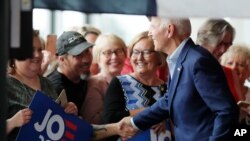 Democratic presidential candidate and former Vice President Joe Biden shakes hands as he arrives for a town hall meeting, in Ottumwa, Iowa, June 11, 2019. 