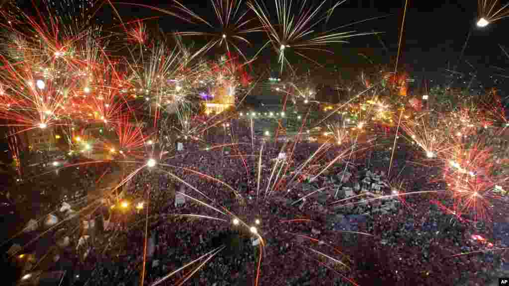 Fireworks light up the sky as opponents of Egypt's ousted president Mohamed Morsi celebrate in Tahrir Square in Cairo, July 3, 2013.
