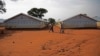 FILE - Refugees walk at the Nyumanzi transit center in Adjumani, Uganda, July 13, 2016. 