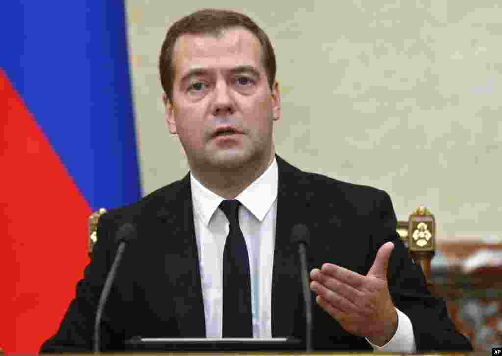 Premier Dmitry Medvedev at the Cabinet meeting announces sanctions, on behalf of the Russian government, banning all imports of meat, fish, milk and milk products, fruits and vegetables from the United States, European Union, Australia, Canada and Norway in Moscow on Thursday, Aug. 7, 2014.