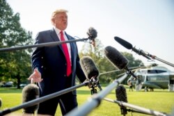President Donald Trump speaks to members of the media on the South Lawn of the White House in Washington, Aug. 7, 2019.