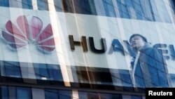 A man walks past a Huawei shop in Beijing, China, March 7, 2019. 