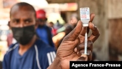 FILE - A health official prepares the Moderna Covid-19 vaccine during a mass Covid-19 vaccination drive in Nairobi, Kenya, Sep. 17, 2021.