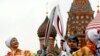 Russian Olympic gold medalists, synchronized swimmer Anastasya Davydova (L) and former artistic gymnast Svetlana Khorkina (R), join their torches during a relay of the Olympic flame in Moscow, Oct. 7, 2013. 