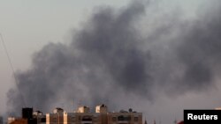 Black smoke marks where clashes are taking place between pro-government forces and an alliance of former anti-Gaddafi rebels, who have joined forces with the Islamist group Ansar al-Sharia in Benghazi, Libya, Aug. 15, 2015. 