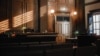 Empty American Style Courtroom. Supreme Court of Law and Justice Trial Stand. Courthouse Before Civil Case Hearing Starts. Grand Wooden Interior with Judge's Bench, Defendant's and Plaintiff's Tables.