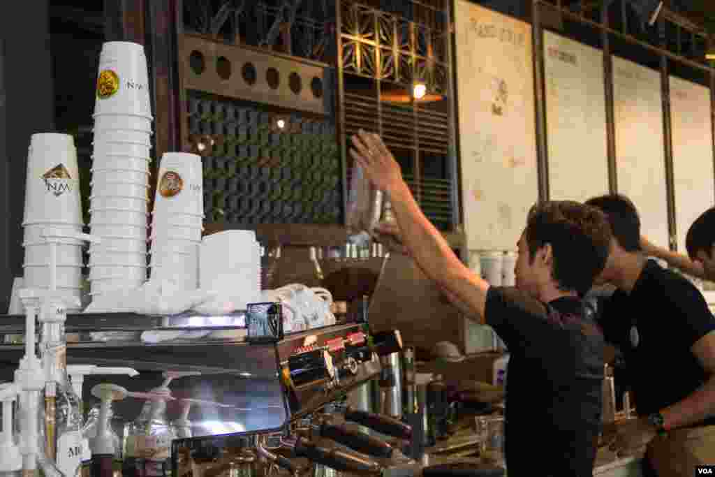A staff is pouring coffee bean into grinder machine at Coffee Brown Roastery on 27th February 2015. 
