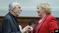Bishop Gerald Kicanas (L), Archdiocese of Tucson, Arizona, speaks with House Judiciary subcommittee on Immigration, Citizenship, Refugees, Border Security, and International Law Chair Zoe Lofgren, before a panel hearing about reform of the US immigration