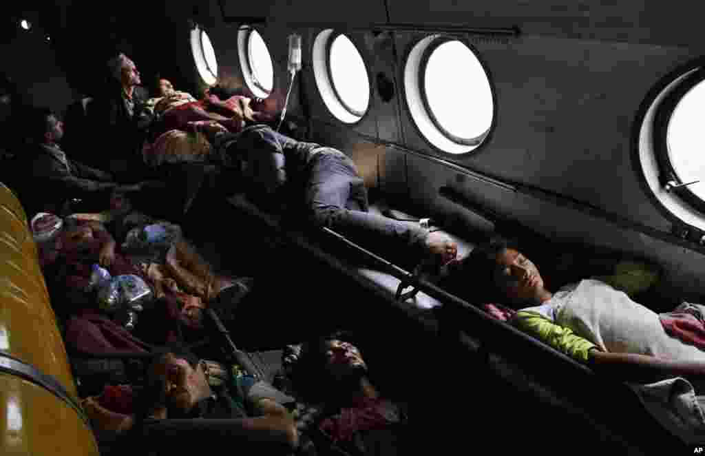 Nepalese victims of Saturday’s earthquake lie inside an Indian air force helicopter as they are evacuated from Trishuli Bazar to Kathmandu airport in Nepal.