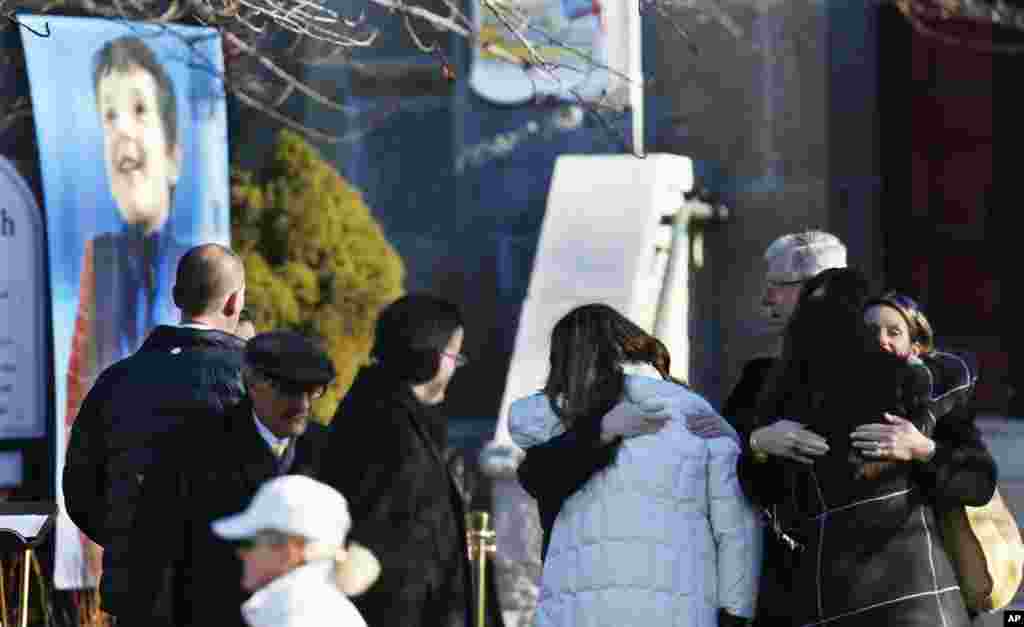A portrait of Benjamin Andrew Wheeler, one of the students killed in the Sandy Hook Elementary School shooting, stands outside of Trinity Episcopal Church before his funeral service, Newton, Connecticut, December 20, 2012.