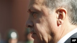 Turkish Prime Minister Recep Tayyip Erdogan walks before a ceremony outside his office in Ankara, Turkey, Sept. 8, 2011.