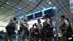 Riot police patrol at the Airport Express central station in downtown Hong Kong, Sept. 7, 2019.