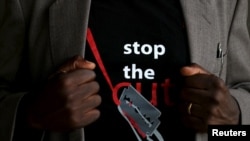 FILE - A man's T-shirt reads "Stop the Cut," referring to female genital mutilation, during an event advocating against such harmful practices at a girls school in Imbirikani, Kenya, April 21, 2016.