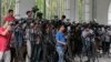 FILE - Reporters cover proceedings outside a court in Dhaka, Bangladesh, May 3, 2016. A Bangladeshi journalists group is expressing outrage over the recent detention and one year sentence given to Bangla Tribune correspondent Ariful Islam. 