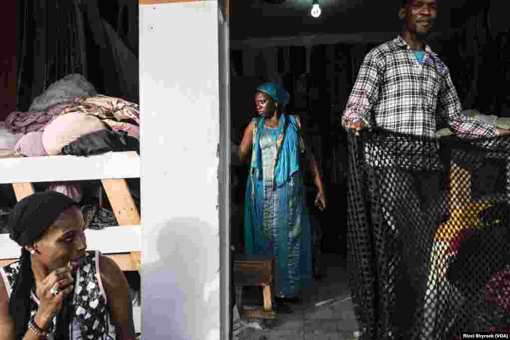 "Fashion is everywhere in Dakar," says Dakar Fashion Week founder and designer Adama Paris, June 29, 2017. As if to prove her point, the stage of DFW's "Street Show" is surrounded on all sides by residents making their living off of clothes -- a shoe seller, a tailor, and pictured here Nichole Coly's fabric store.