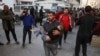A man carries a Palestinian casualty to a hospital, in the aftermath of an Israeli strike, in Gaza City, Dec. 19, 2024. 