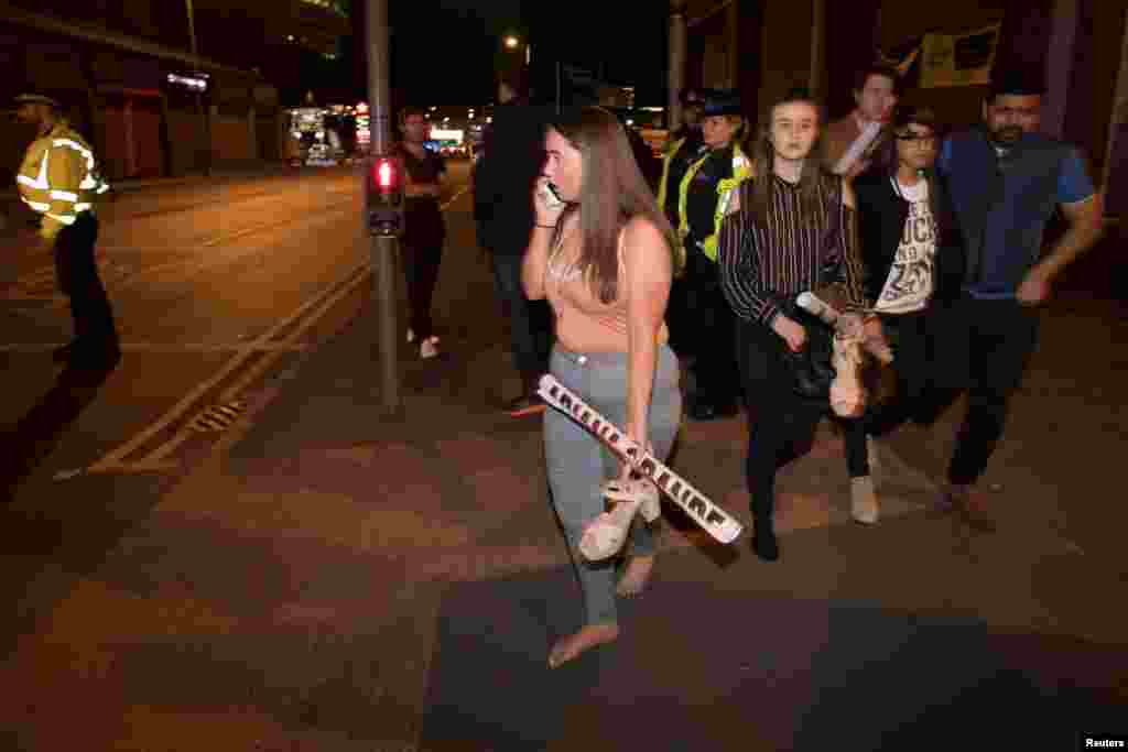 Concert goers react after fleeing the Manchester Arena in northern England where U.S. singer Ariana Grande had been performing in Manchester, Britain, May 22, 2017.