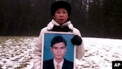 Chea Vichea's wife holding a picture of her late husband, Chea Vichea, file photo. 