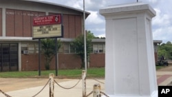 A pedestal that held a statue of Robert E. Lee stands empty outside a high school named for the Confederate general in Montgomery, Ala. on Tuesday, June 2, 2020. (AP Photo/Kim Chandler)