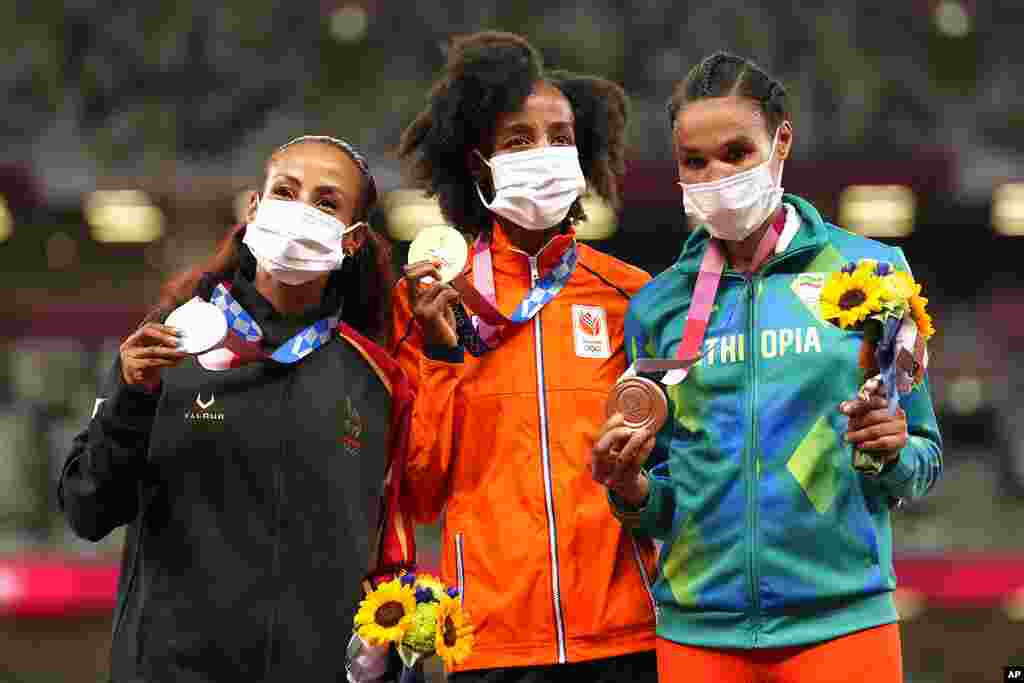 Gold medalist Sifan Hassan, of Netherlands, center, stands with silver medalist Kalkidan Gezahegne, of Bahrain, left, and bronze medalist Letesenbet Gidey, of Ethiopia, during the medal ceremony for the women's 10,000-meters at the 2020 Summer Olympics, Saturday, Aug. 7, 2021, in Tokyo. (AP Photo/Martin Meissner)