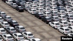 FILE - Cars ready for export at the port of Taipei, northern Taiwan, April 16, 2014. 