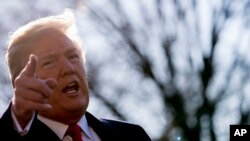 FILE - President Donald Trump speaks to reporters before boarding Marine One on the South Lawn of the White House in Washington, March 13, 2018, to travel to Andrews Air Force Base, Maryland. 