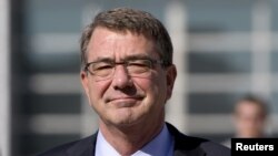 FILE - U.S. Defense Secretary Ash Carter walks on the tarmac before boarding his plane at Queen Alia Airport in Amman, Jordan, July 24, 2015.