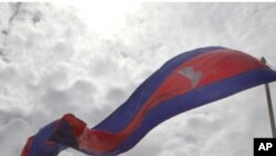 Cambodian flags flutter near a bridge where an accident took place last year during a ground breaking ceremony in Phnom Penh, Cambodia,Thursday, Aug. 11, 2011. At least 353 people were killed and 395 injured when thousands of festival-goers crammed onto a
