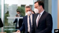 German Health Minister Jens Spahn, right, and Lothar H. Wieler, left, president of the Robert-Koch-Institute, said at a press conference in Berlin, Germany, there were 25,000 new infections reported as of Friday.