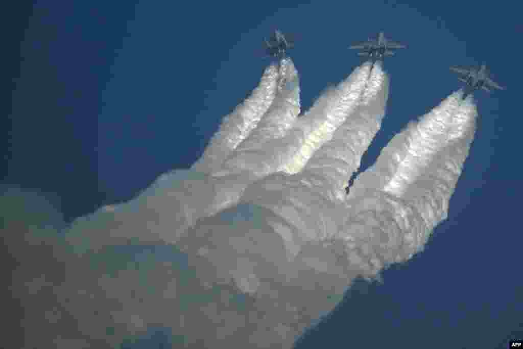 The Indian Air Force (IAF) Sukhoi Su-30 fighter jets perform during the inaugural day of the 15th edition of 'Aero India 2025', a military aviation exhibition, at the Yelahanka Air Force Station in Bengaluru.