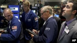 Traders work on the floor at the New York Stock Exchange in New York, Oct. 31, 2012. 